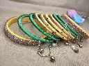 Golden Yellow & Emerald Green Thread Bangles with Pearl & Bell Charm Chain-PRISHAN-1.webp